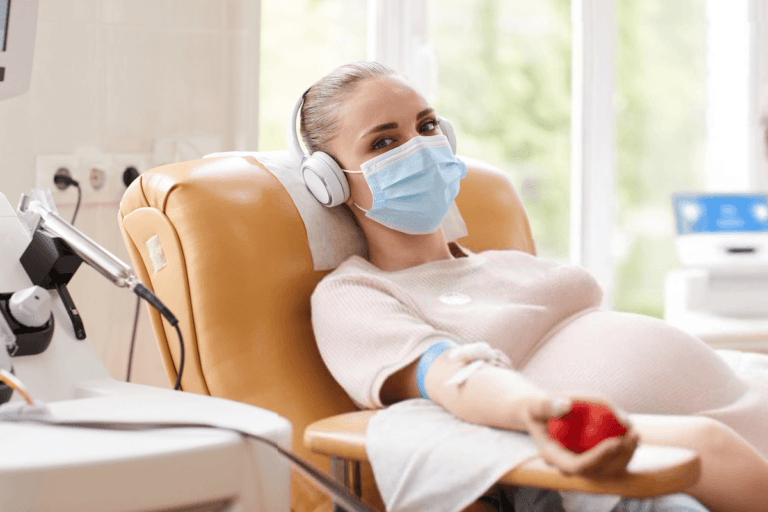 Pregnant woman undergoing a blood infusion, showcasing how this procedure helps treat iron deficiency during pregnancy.