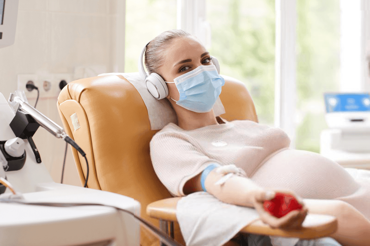 Pregnant woman undergoing a blood infusion, showcasing how this procedure helps treat iron deficiency during pregnancy.