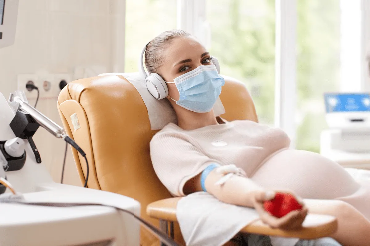 Pregnant woman undergoing a blood infusion, showcasing how this procedure helps treat iron deficiency during pregnancy.