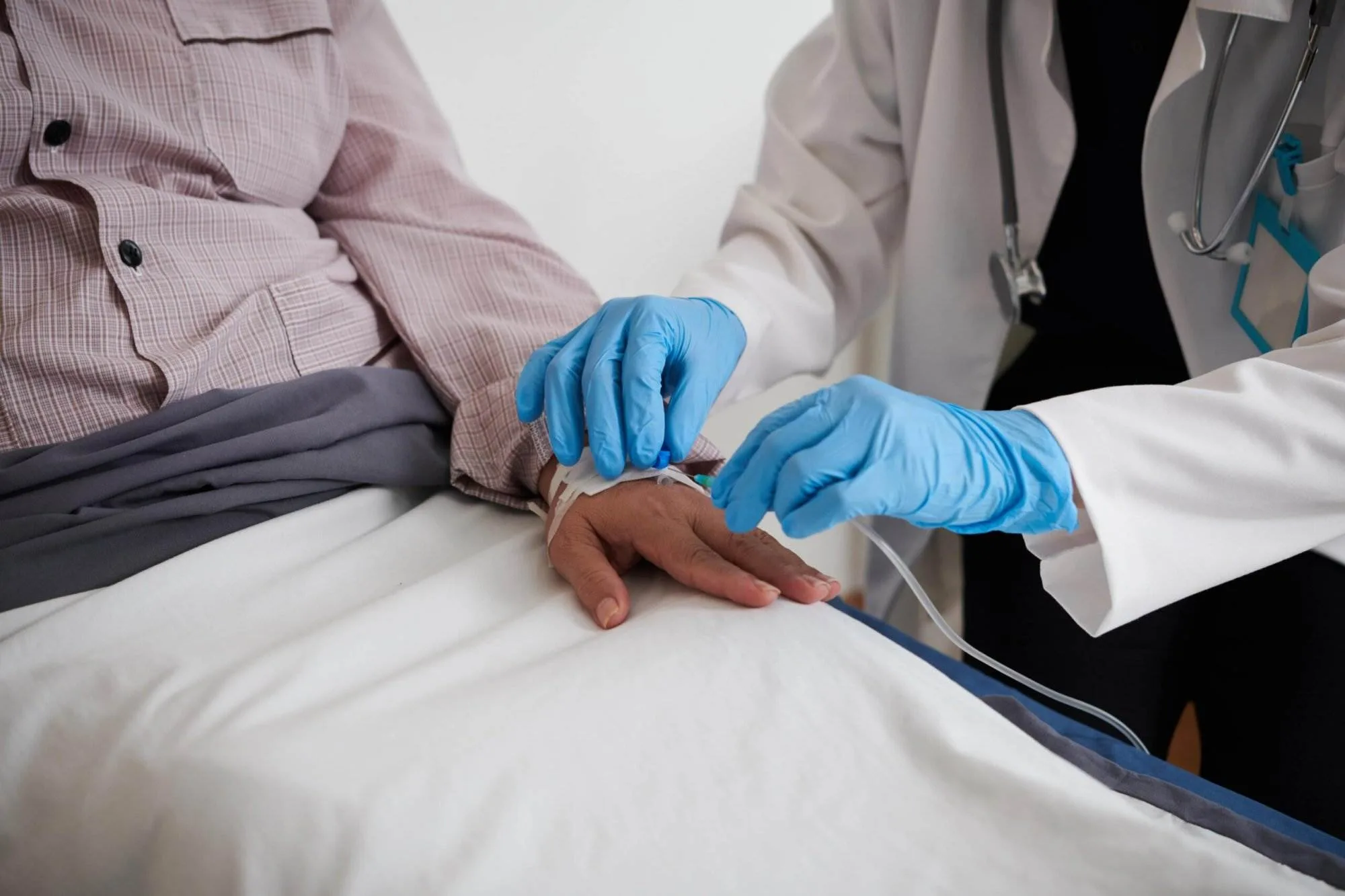 Trained professional inserting IV therapy