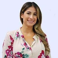 Nurse Practitioner Jiselle Silva with a friendly smile in a floral blouse, representing hematology care.